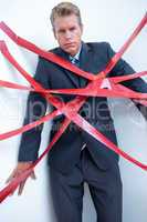 Businessman trapped by red tape