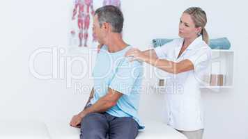 Doctor examining her patient neck