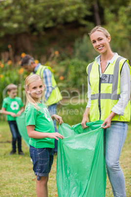 Happy family collecting rubbish