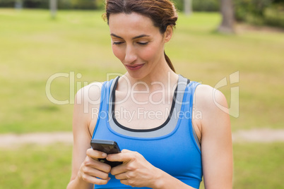 Pretty brunette using smartphone