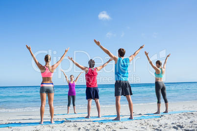 Friends stretching together with their teacher