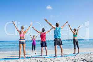 Friends stretching together with their teacher