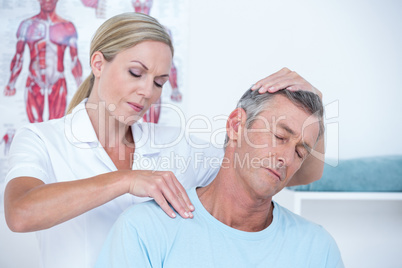 Doctor examining her patient neck