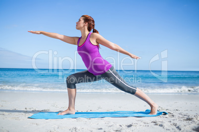 Brunette doing yoga on exercise mat