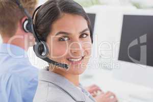 Smiling businesswoman wearing headset