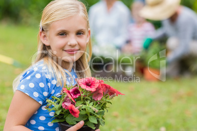 Young girl sitting with flower pot