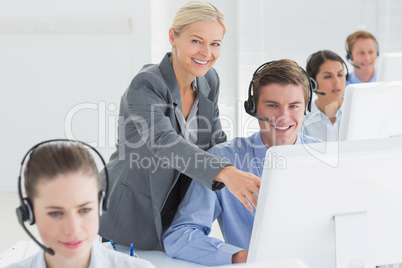 Manager helping call centre employee