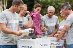 Happy volunteer looking at donation box