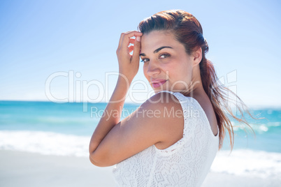 Pretty brunette relaxing beside the water