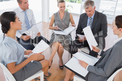 Business team sitting in circle and discussing