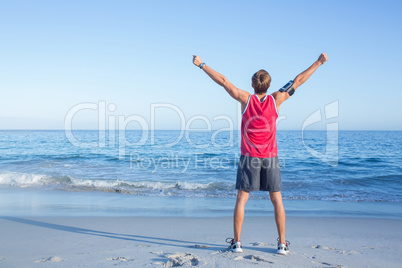 Handsome man raising arms