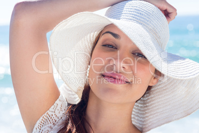 Pretty brunette wearing sunhat and looking at camera