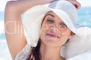 Pretty brunette wearing sunhat and looking at camera