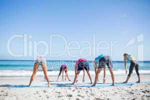 Friends doing yoga together with their teacher