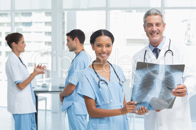 Male and female doctors examining x-ray