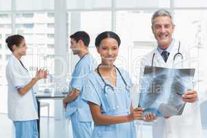 Male and female doctors examining x-ray