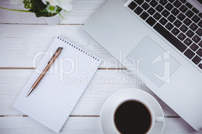 Overhead shot of laptop and notepad