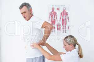 Doctor examining her patient back