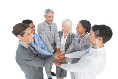 Executives holding hands together in office