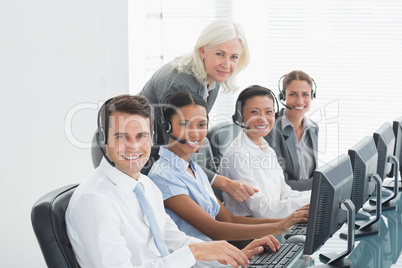 Businesswoman with executives using computers