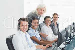 Businesswoman with executives using computers