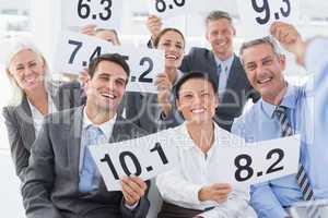 Interview panel holding score cards in office