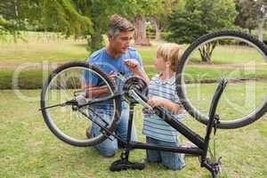 Father and his son fixing a bike