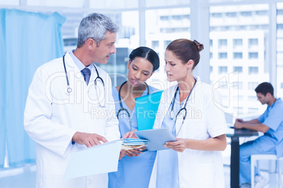 Male and female doctors working on reports