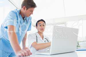 Doctors working on laptop computer