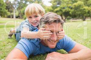 Happy father and his son smiling at camera