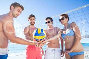Group of friends holding volleyball
