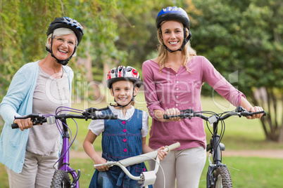 Happy multi generation family on their bike at the park