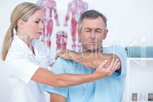 Doctor stretching a man arm