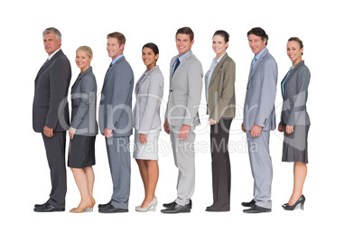 Business team standing in row and smiling at camera