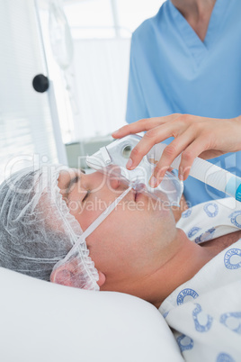 Doctor holding patients oxygen mask