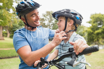 Happy father on a bike with his son