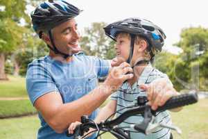 Happy father on a bike with his son