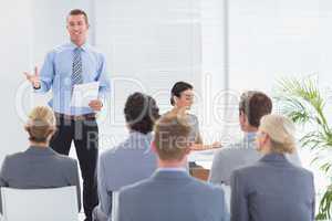 Smiling businessman talking during conference