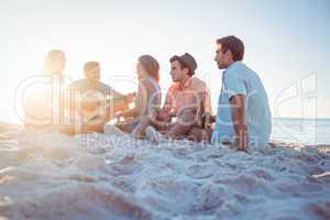 Happy hipsters relaxing and playing guitar