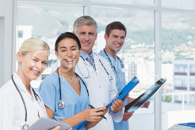 Team of smiling doctors looking at camera