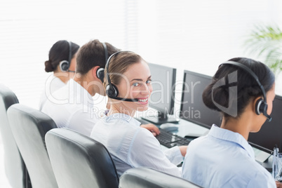 Business people with headsets using computers