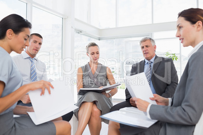 Business team sitting in circle and discussing