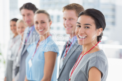 Business team standing in row and smiling at camera