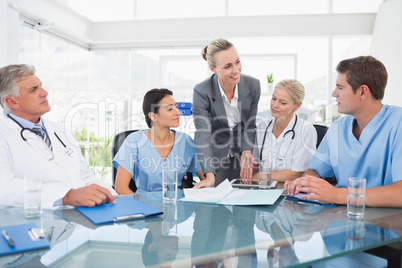 Team of doctors and businesswoman having a meeting