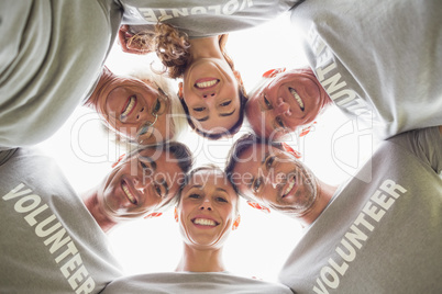 Happy volunteer family looking down at the camera