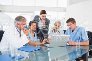 Team of doctors and businesswoman having a meeting