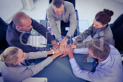 Business team putting their hands together