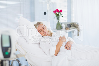 Happy patient lying on her bed