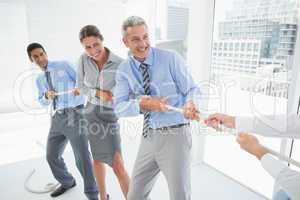 Business people pulling rope