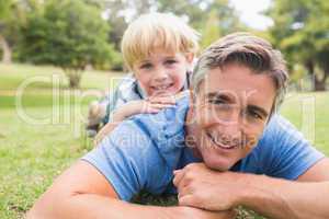 Happy father and his son smiling at camera